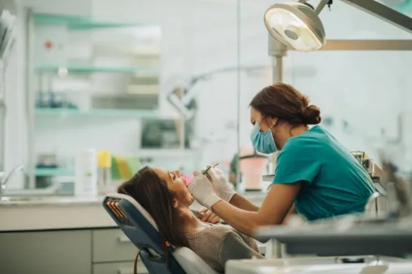 Dental works; a dentist checking a patient's mouth