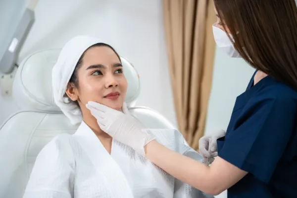 Facial treatments, doctor caring for a patient.