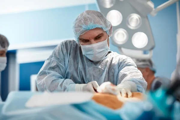 Liposuction cost, doctor performing surgery.