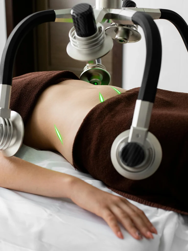 A patient lying down while a high-tech body analysis machine scans treatment areas, helping determine how much is liposuction.