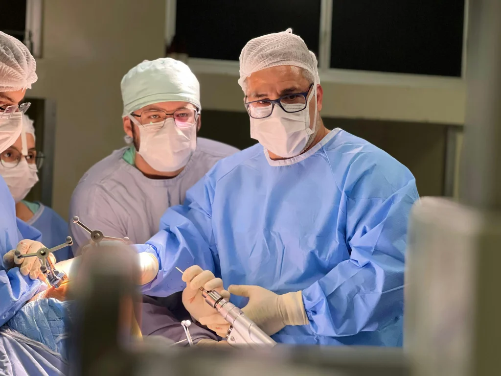 A team of surgeons performing a liposuction procedure in an operating room – understanding how much is liposuction depends on various factors like treatment areas and technique.