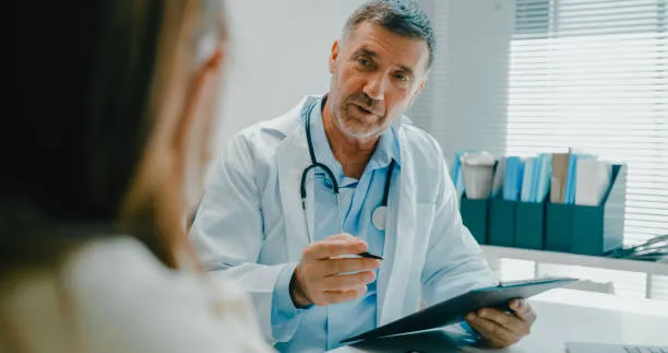 Doctor explaining how much does liposuction cost during a consultation