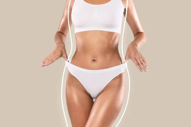 Woman with a slim abdomen showing the body contour results after a liposuction procedure.