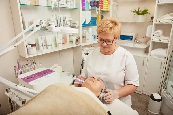 A skilled aesthetician performing a detailed facial treatment on a client, highlighting the importance of choosing the best clinic for quality care